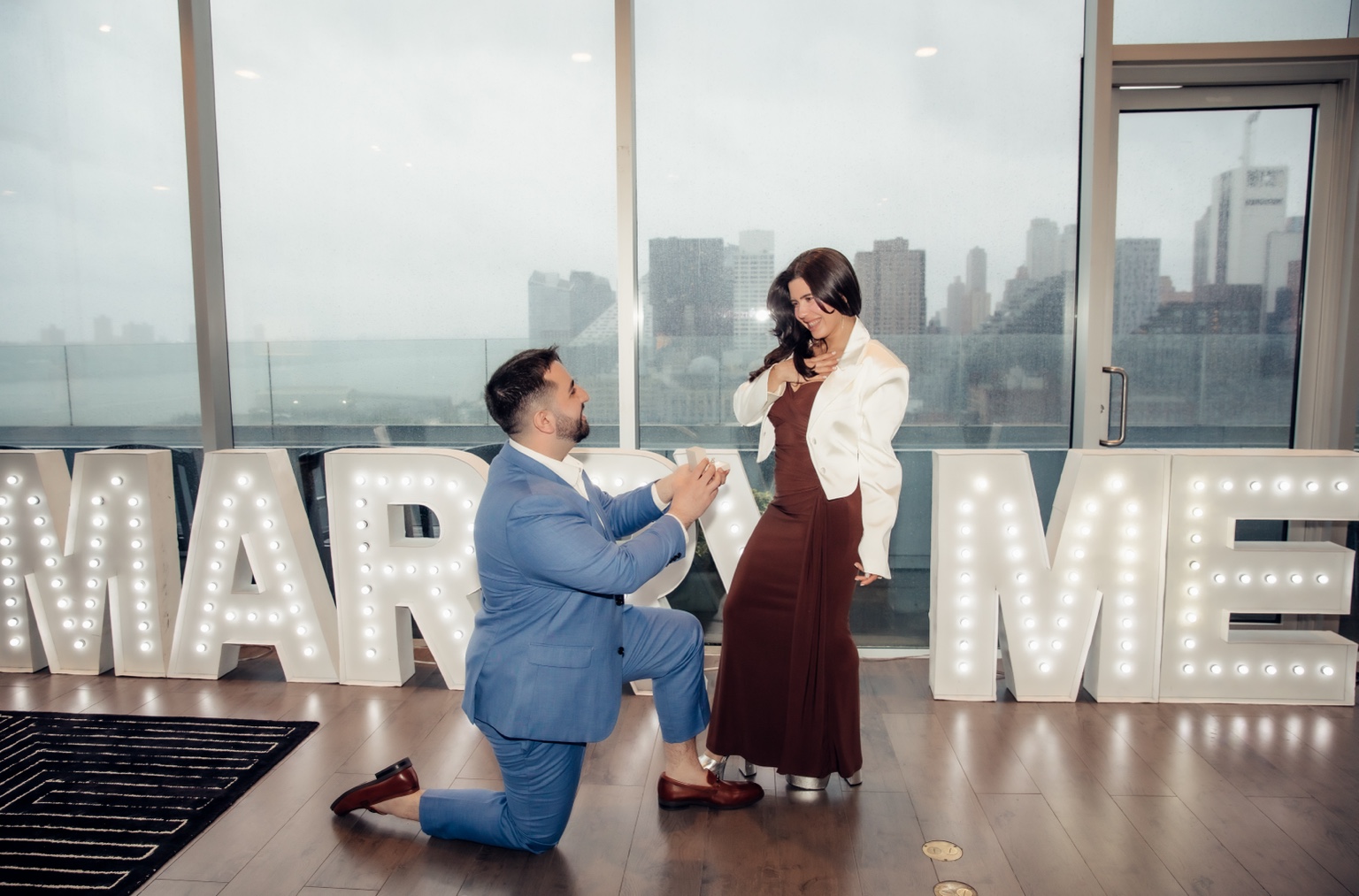 Connor on one knee proposing to Ingrid